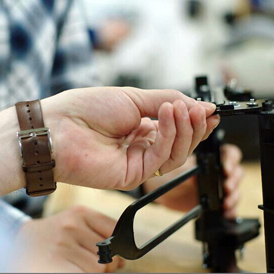 Clek engineers working on a car seat component