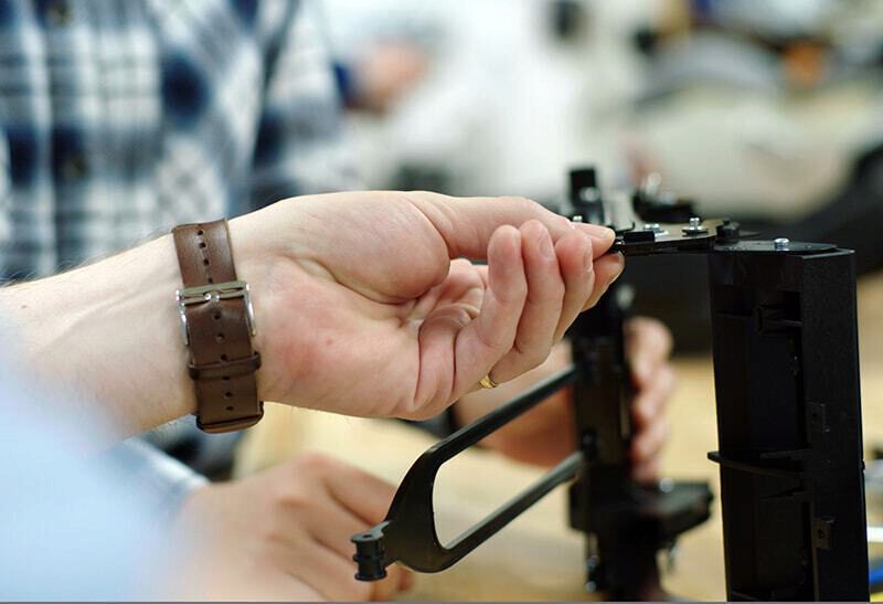 Clek engineers working on a car seat component