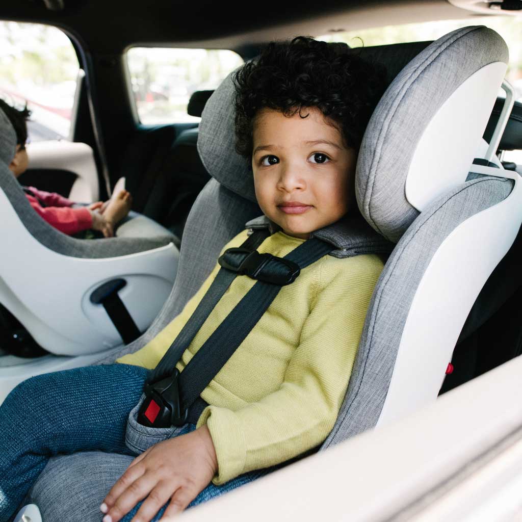 Boy sitting in his Clek Foonf convertible car seat
