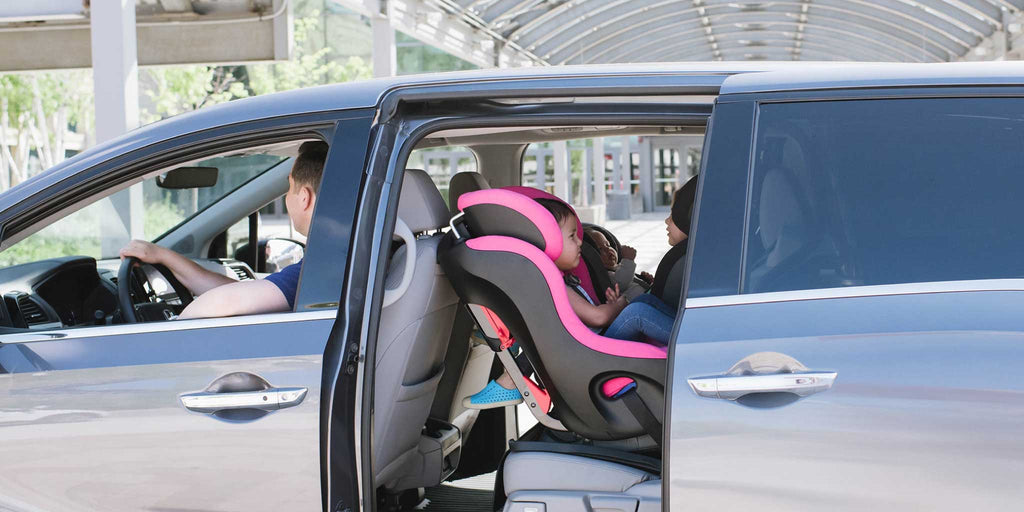 Clek Fllo convertible car seat installed in rear-facing position in a minivan