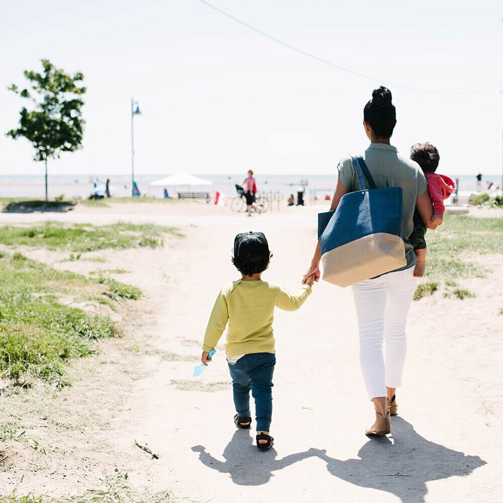 Mother walking with her son to the beach
