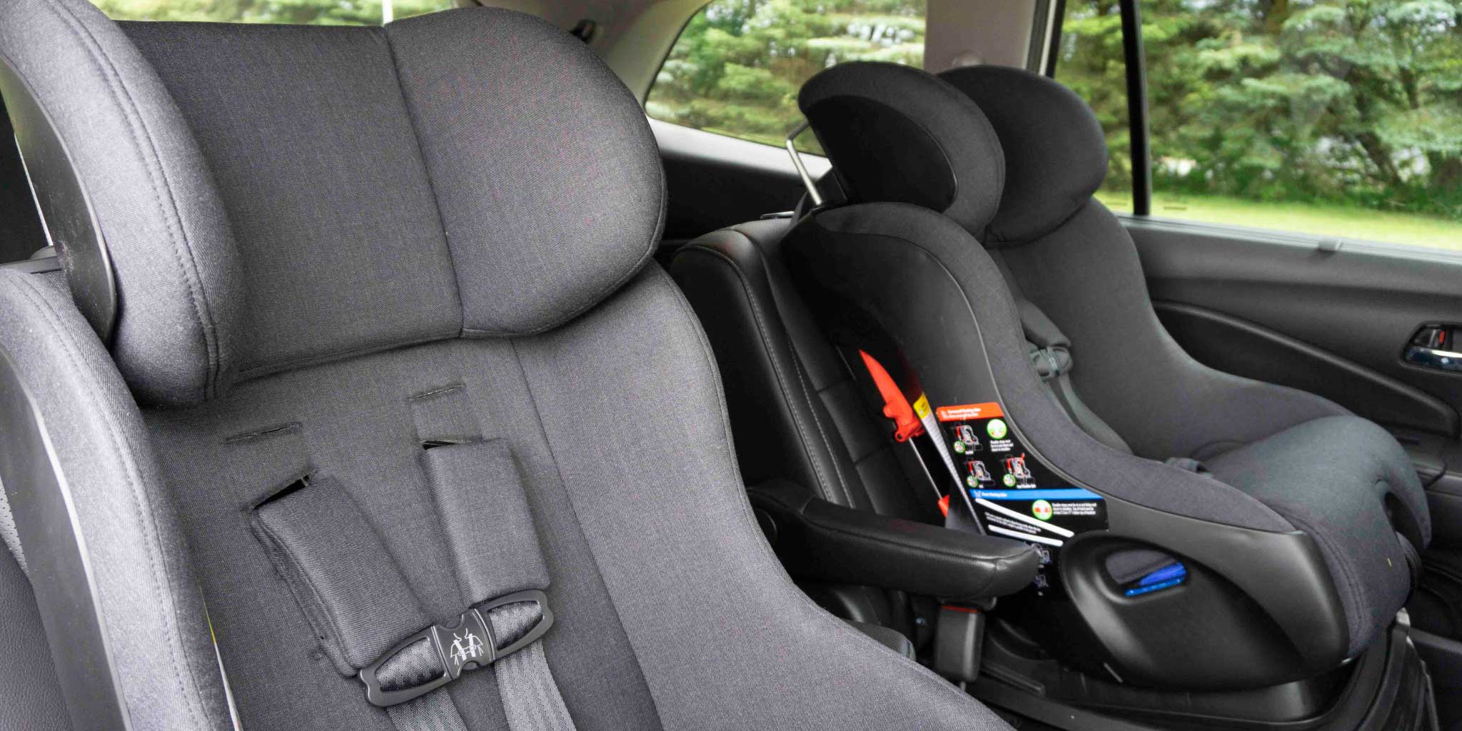 Clek Fllo and Foonf Convertible Car Seats in mammoth fabric installed in an SUV