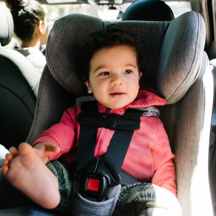 Toddler seated rear-facing in their Clek convertible car seat
